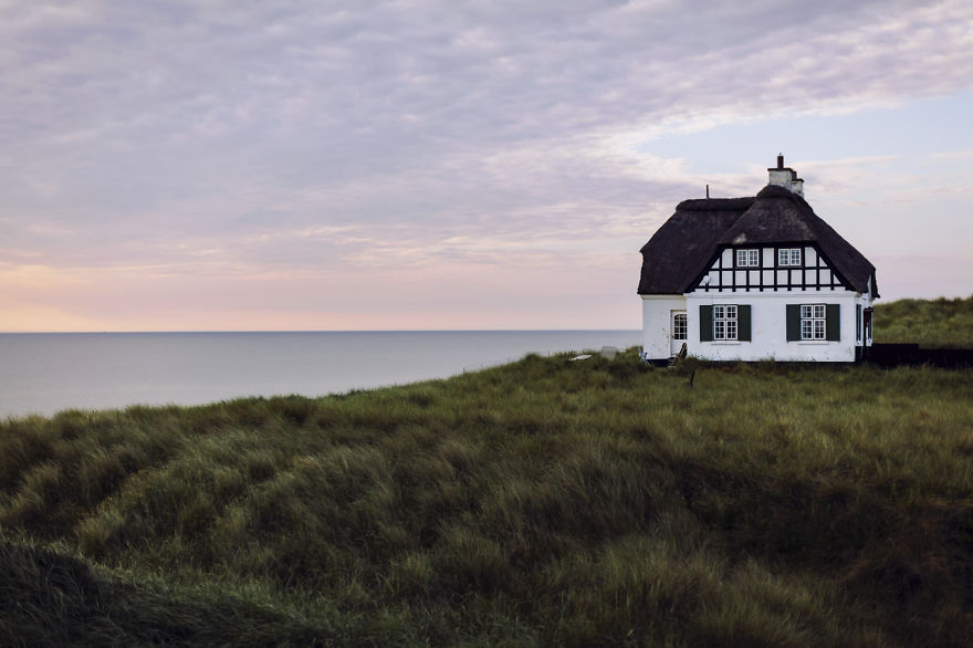 house on coastline at sunset