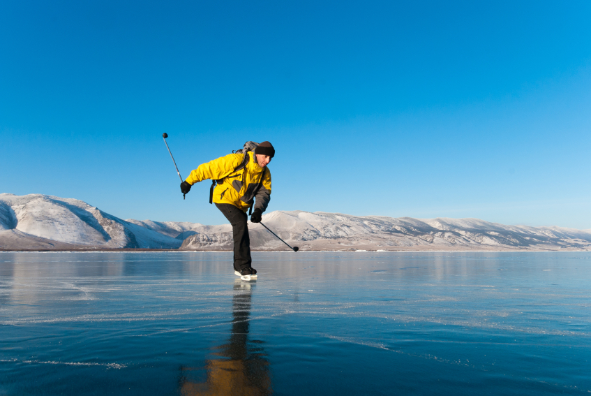 Skating man at the ice of lake Baikal